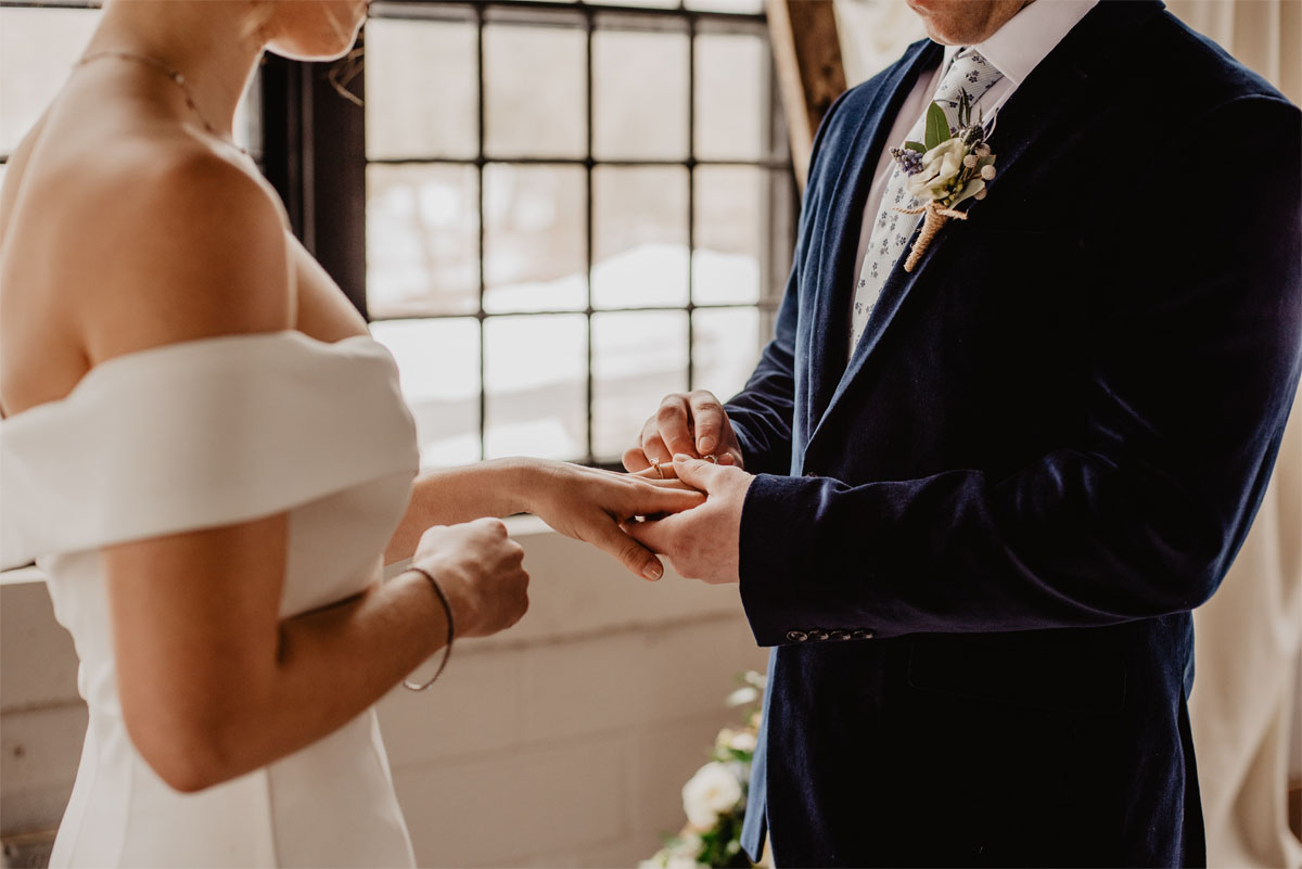 Bride and Groom exchanging rings during their wedding ceremony.