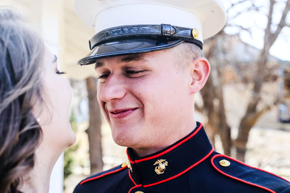 Groom wearing military uniform at his wedding.